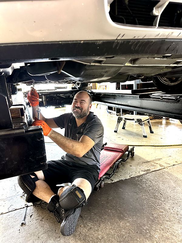 West Goshen Automotive & Fleet Services technician performing undercarriage repair in the West Chester, PA shop