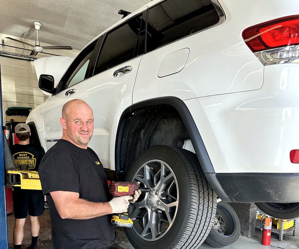 West Goshen Automotive & Fleet Services technician servicing a wheel in the West Chester, PA shop