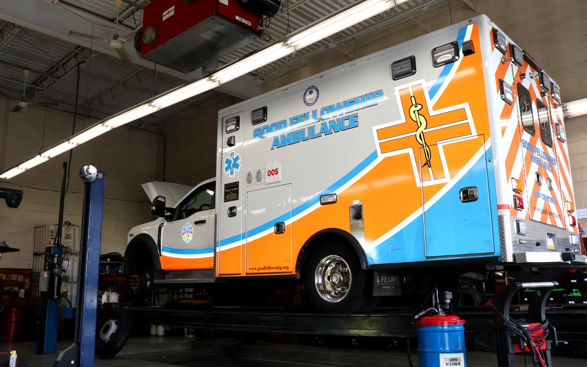 Good Fellowship Ambulance vehicle raised on a lift for service at West Goshen Automotive & Fleet Services in West Chester, PA